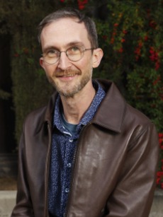 Thomas Fuhr wearuing leather jacket in front of flowering plants