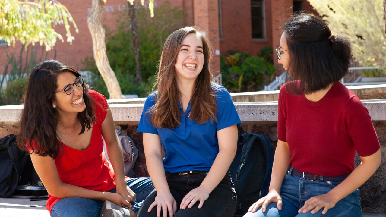 3 young women laughing and smiling